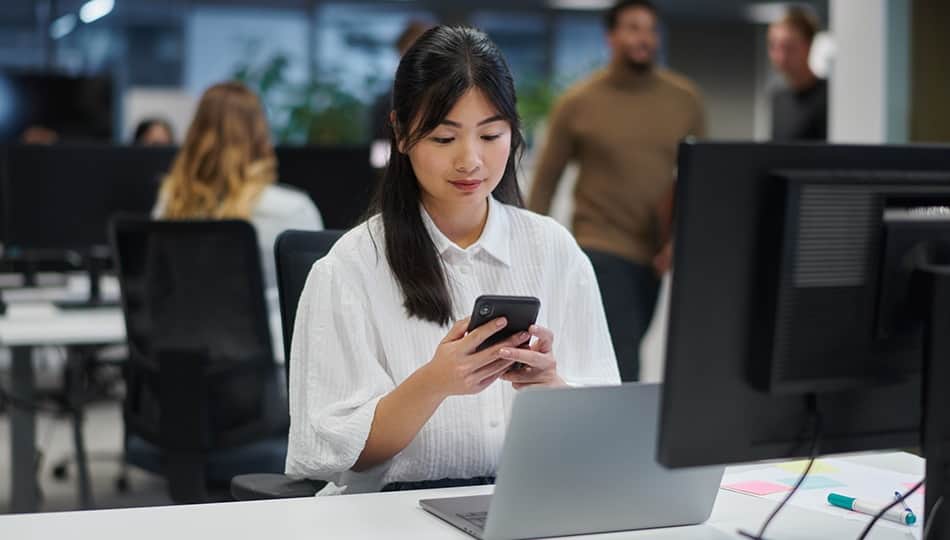 Woman on her phone at the office